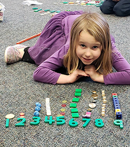 Girl working on counting items from 1 to 9